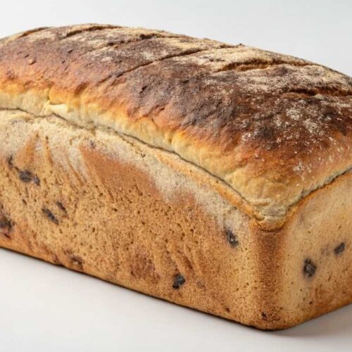 Freshly baked garbage bread recipe with melted cheese and savory fillings